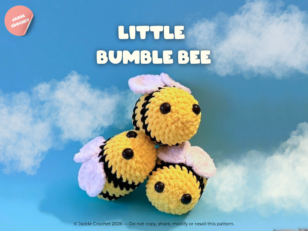 Crocheted bee toy with a blue sky background