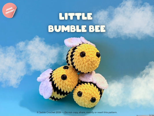 Crocheted bee toy with a blue sky background
