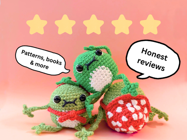 Two green crocheted characters with speech bubbles indicating 'Patterns, books & more' and 'Honest reviews' on a pink background with five yellow stars.